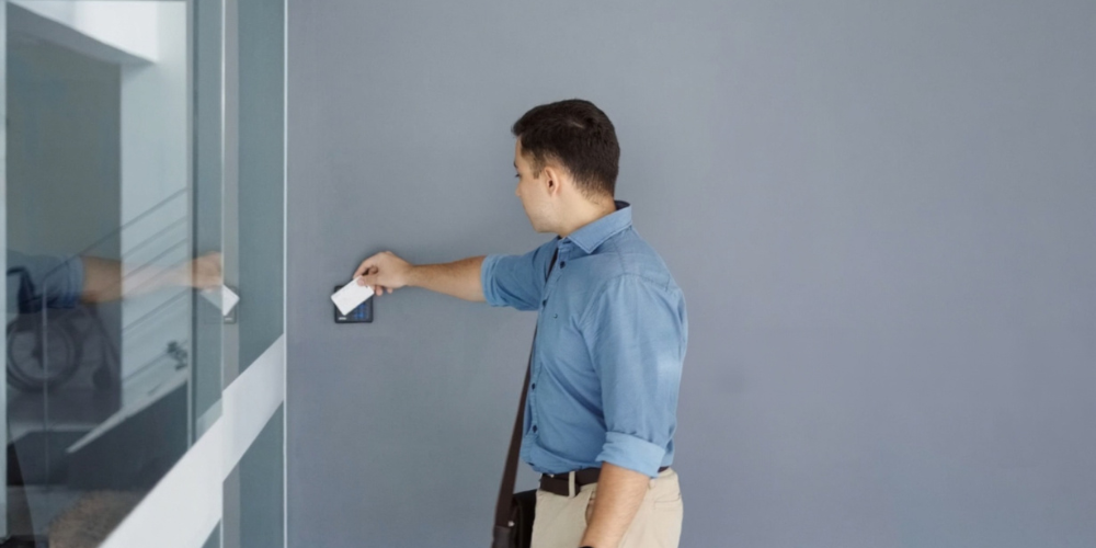 em-lock-common-use Employee using an access card on a reader to unlock the EM lock door