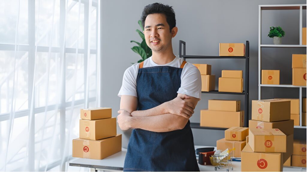pos-sytem-singapore-article-image_upscaled Happy small business owner standing behind the counter with a POS system